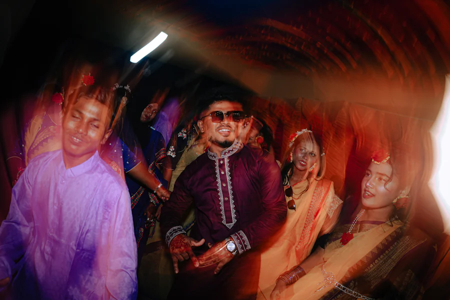 Guests dancing at a sangeet night, colour and motion blurring across the frame